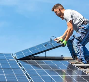 Solar technician installing panels